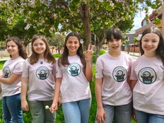 Photo of the students who created Helpie standing outside wearing matching tshirts. 